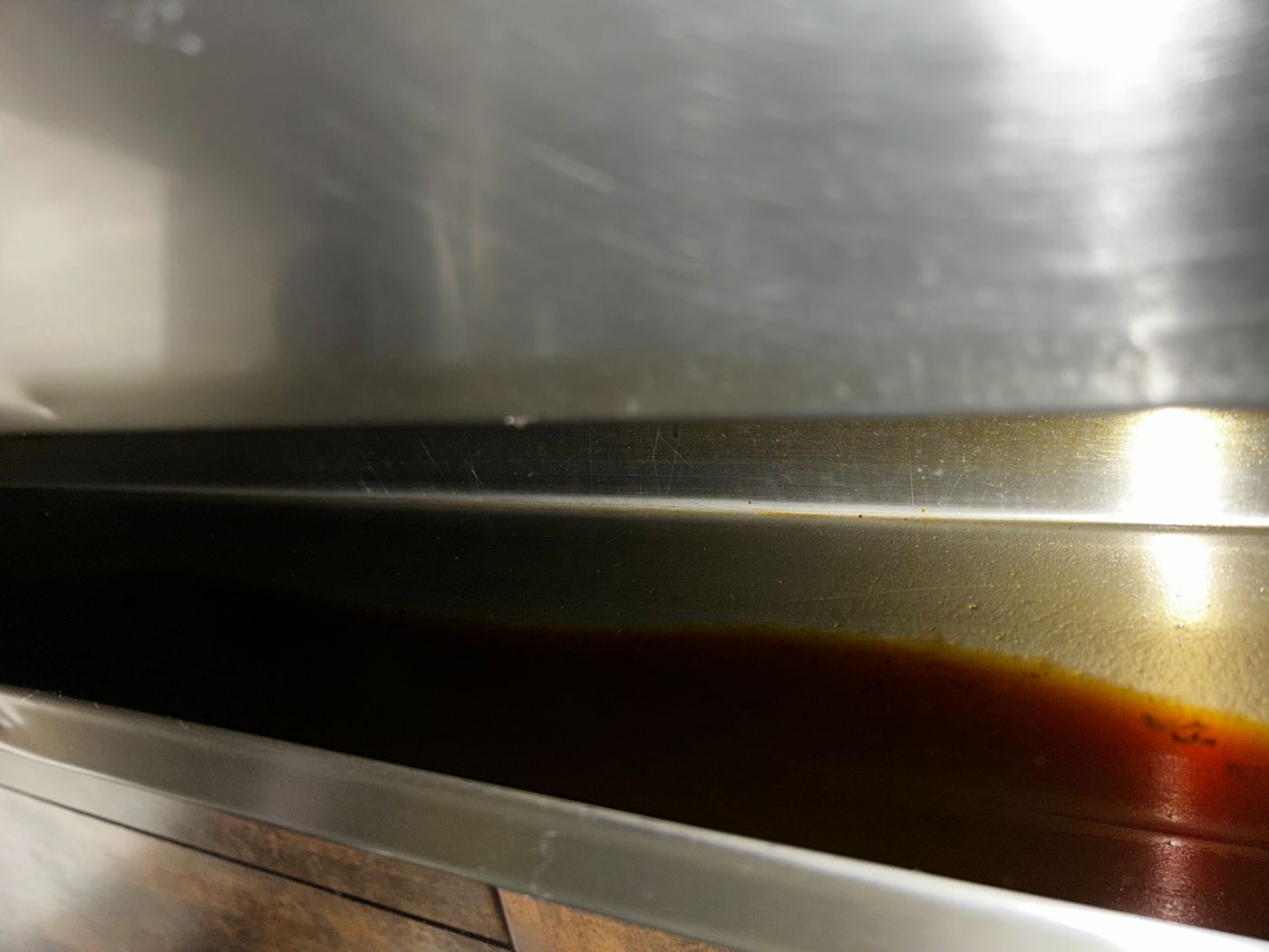 Grease pooled in canopy trough before cleaning